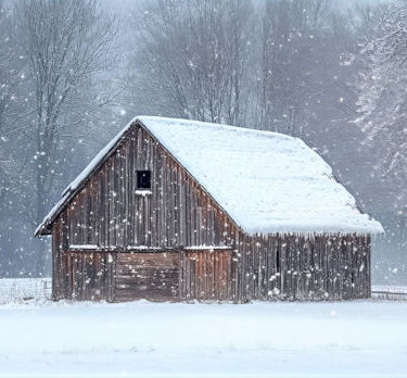 An old barn in a snowstorm